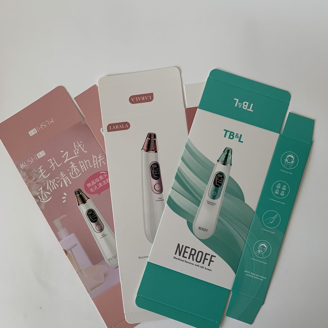 Three printed folding cartons in white, terracotta and kraft board